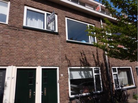 Bakstenen gevel met groene voordeuren aan de Azaleastraat in Utrecht